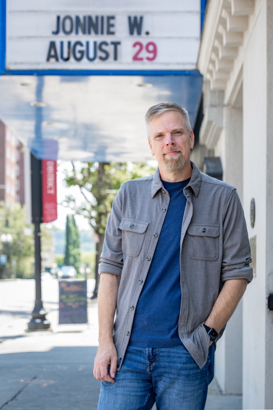 Jonnie W. standing under a theater marquee with his name on it